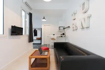 a living room with a black couch and a table at Troon of Athens Apartments in Athens