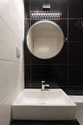 a bathroom with a sink and a mirror on the wall at Troon of Athens Apartments in Athens