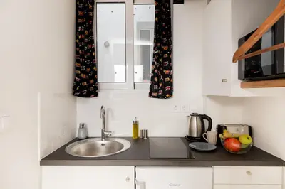 a kitchen counter with a sink and a window at Troon of Athens Apartments in Athens