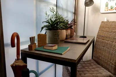 a table with a chair and plants on it at Magtsi apartment in Athens