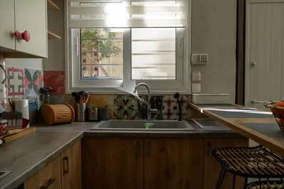 a kitchen with a sink and a window at Magtsi apartment in Athens
