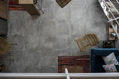a living room with a stone wall and a blue couch at Magtsi apartment in Athens