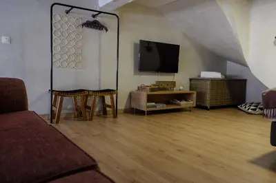 a living room with a couch and a flat screen tv at Magtsi apartment in Athens