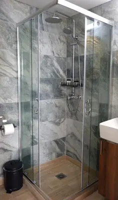 a shower with a glass enclosure in a bathroom at Magtsi apartment in Athens