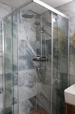 a shower with a glass door in a bathroom at Magtsi apartment in Athens