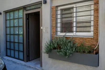 a building with a door and a window and plants at Magtsi apartment in Athens
