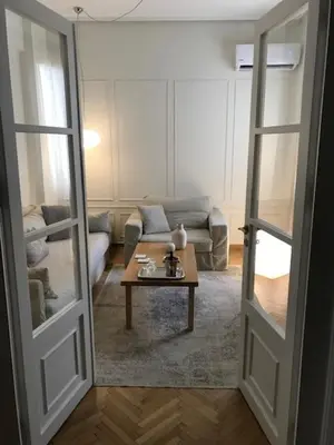 a living room with a couch and a coffee table at API Projects Athens - Cartier Apartment in Athens