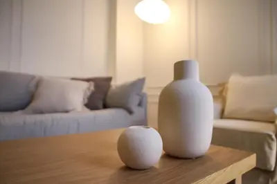 a living room with a vase and a ball on a table at API Projects Athens - Cartier Apartment in Athens