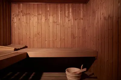 a small wooden sauna with a bucket in it at Brown Acropol, a member of Brown Hotels in Athens