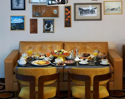 a dining room table with food and drinks on it at Brown Acropol, a member of Brown Hotels in Athens