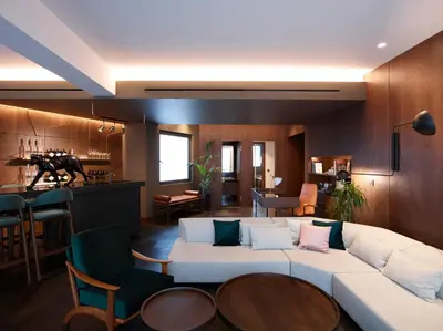 a living room with a white couch and a table at Brown Acropol, a member of Brown Hotels in Athens
