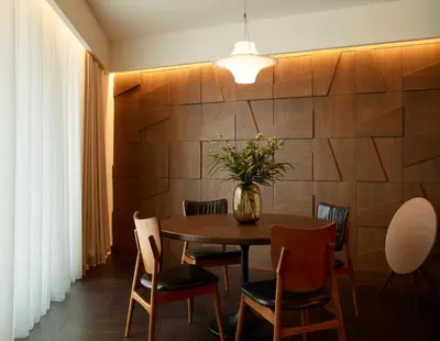 a dining room with a table and chairs and a vase with flowers at Brown Acropol, a member of Brown Hotels in Athens