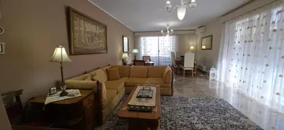 a living room with a couch and a table at Cosy apartment in Chalandri in Athens