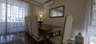 a dressing room with a table and a mirror at Cosy apartment in Chalandri in Athens
