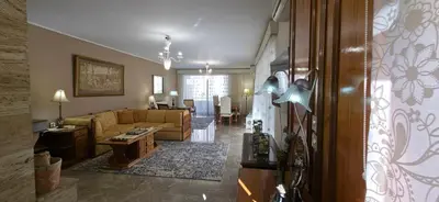 a living room with a couch and a table at Cosy apartment in Chalandri in Athens