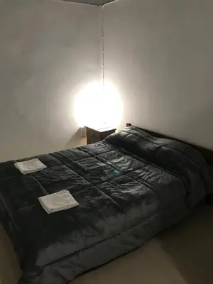 a bedroom with a black bed with a light on it at Factory in Athens
