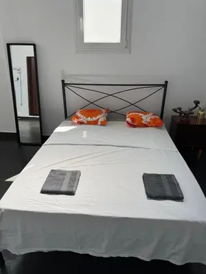 a bedroom with a bed with two pillows on it at Factory in Athens