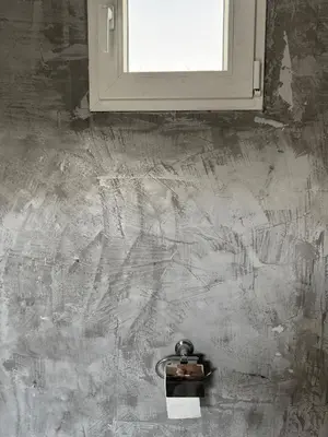 a bathroom with a window and aaucet on a wall at Factory in Athens