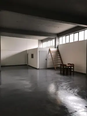 an empty room with a staircase and a table at Factory in Athens