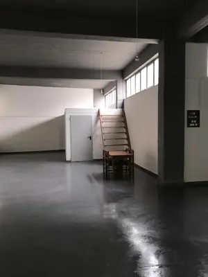 an empty room with a chair and a refrigerator at Factory in Athens