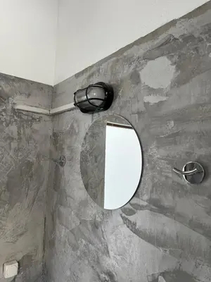 a mirror on the wall of a bathroom at Factory in Athens