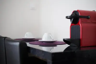 a table with two cups and plates on it at Syntagma Rita apartment 2 in Athens