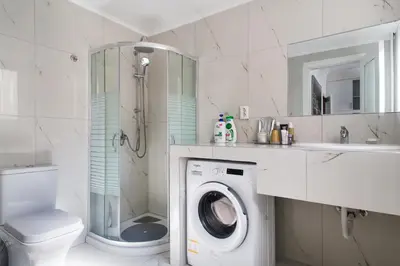 a bathroom with a washing machine and a sink at Syntagma Rita apartment 2 in Athens