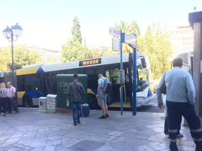 a group of people standing outside of a bus at Syntagma Rita apartment 2 in Athens