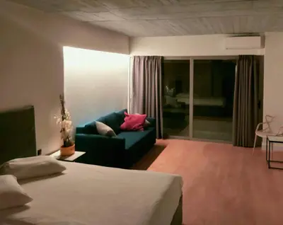 a hotel room with a bed and a couch at The Link Athens in Athens
