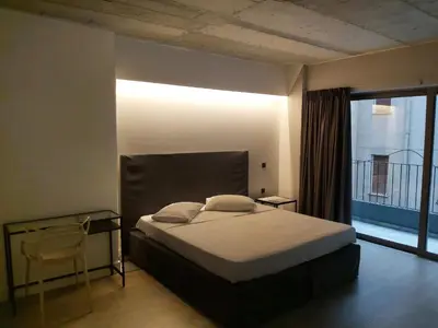 a bedroom with a bed and a large window at The Link Athens in Athens