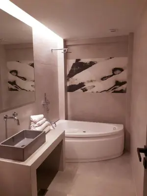a bathroom with a tub and a sink and a bath tub at The Link Athens in Athens