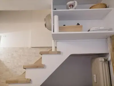 a staircase in a room with white walls at Acropolis Elegant Maisonette by LODGESPOT in Athens
