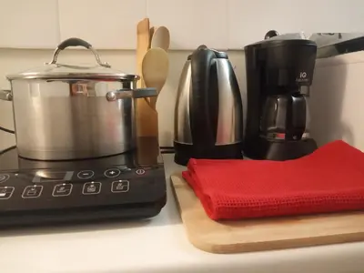 a kitchen counter with a coffee pot on a stove at Acropolis Elegant Maisonette by LODGESPOT in Athens