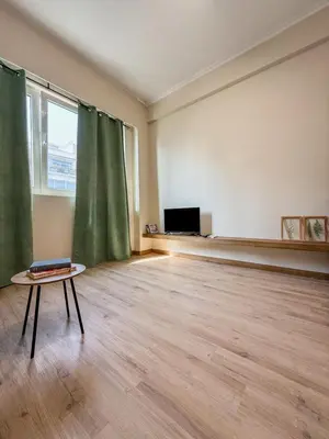an empty room with a table in front of a window at AS Modern Monastiraki Apartment 1A in Athens