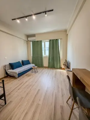 a living room with a couch and a table at AS Modern Monastiraki Apartment 1A in Athens
