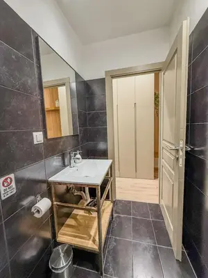 a bathroom with a white sink and a mirror at AS Modern Monastiraki Apartment 1A in Athens