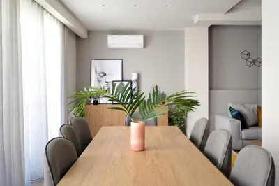 a dining room with a wooden table and chairs at Urban Melodies Apartment in Athens