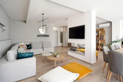 a living room with a couch and a tv at Urban Melodies Apartment in Athens