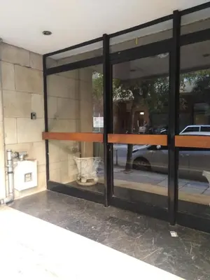 a glass window with a table and a car outside at Urban Melodies Apartment in Athens