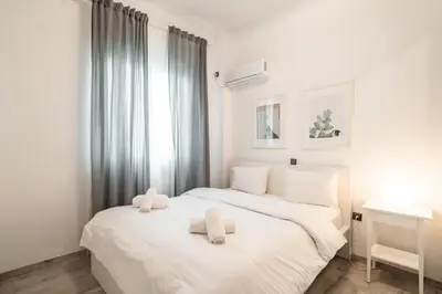 a bedroom with a white bed with two pillows on it at Urban Serenity Gem in Kallithea neighbourhood! in Athens