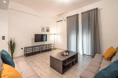 a living room with a couch and a coffee table at Urban Serenity Gem in Kallithea neighbourhood! in Athens