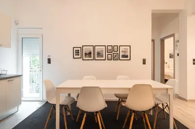 a white dining room with a white table and chairs at Urban Serenity Gem in Kallithea neighbourhood! in Athens