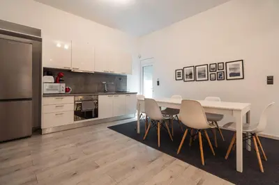 a kitchen with a table and chairs in a room at Urban Serenity Gem in Kallithea neighbourhood! in Athens