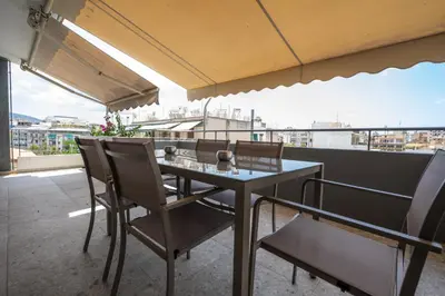 a table and chairs on a balcony with a view at Trojan Affair Residence in Athens