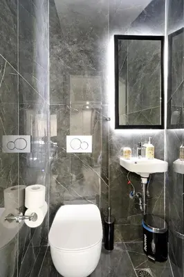 a bathroom with a toilet and a sink and a mirror at Trojan Affair Residence in Athens