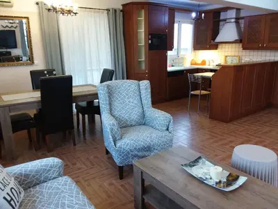 a kitchen and living room with a table and chairs at Gazi view apartments #1 in Athens