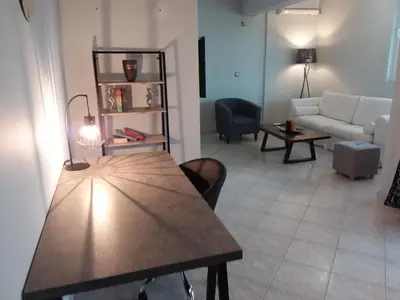 a living room with a table and a couch at Gazi view apartments #1 in Athens