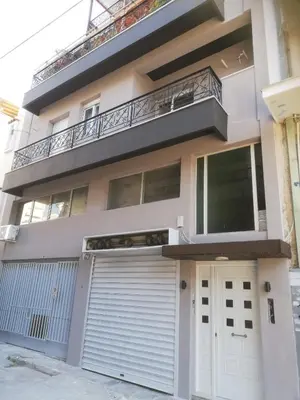 an apartment building with a gate and a garage at Gazi view apartments #1 in Athens