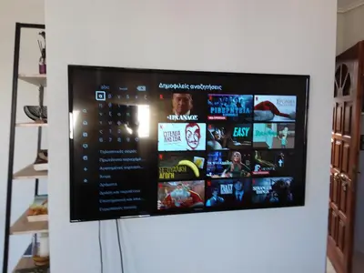 a flat screen tv hanging on a wall at Gazi view apartments #1 in Athens