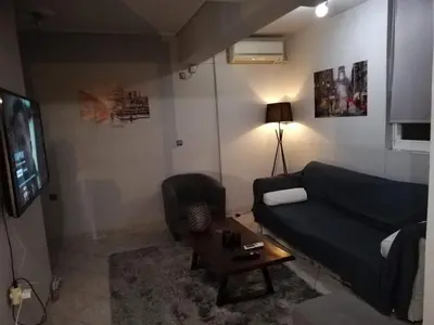 a living room with a couch and a tv at Gazi view apartments #1 in Athens